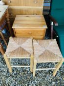 A HONEY PINE THREE DRAWER BEDSIDE CHEST AND PAIR OF BEECHWOOD STOOLS WITH RUSH SEATS