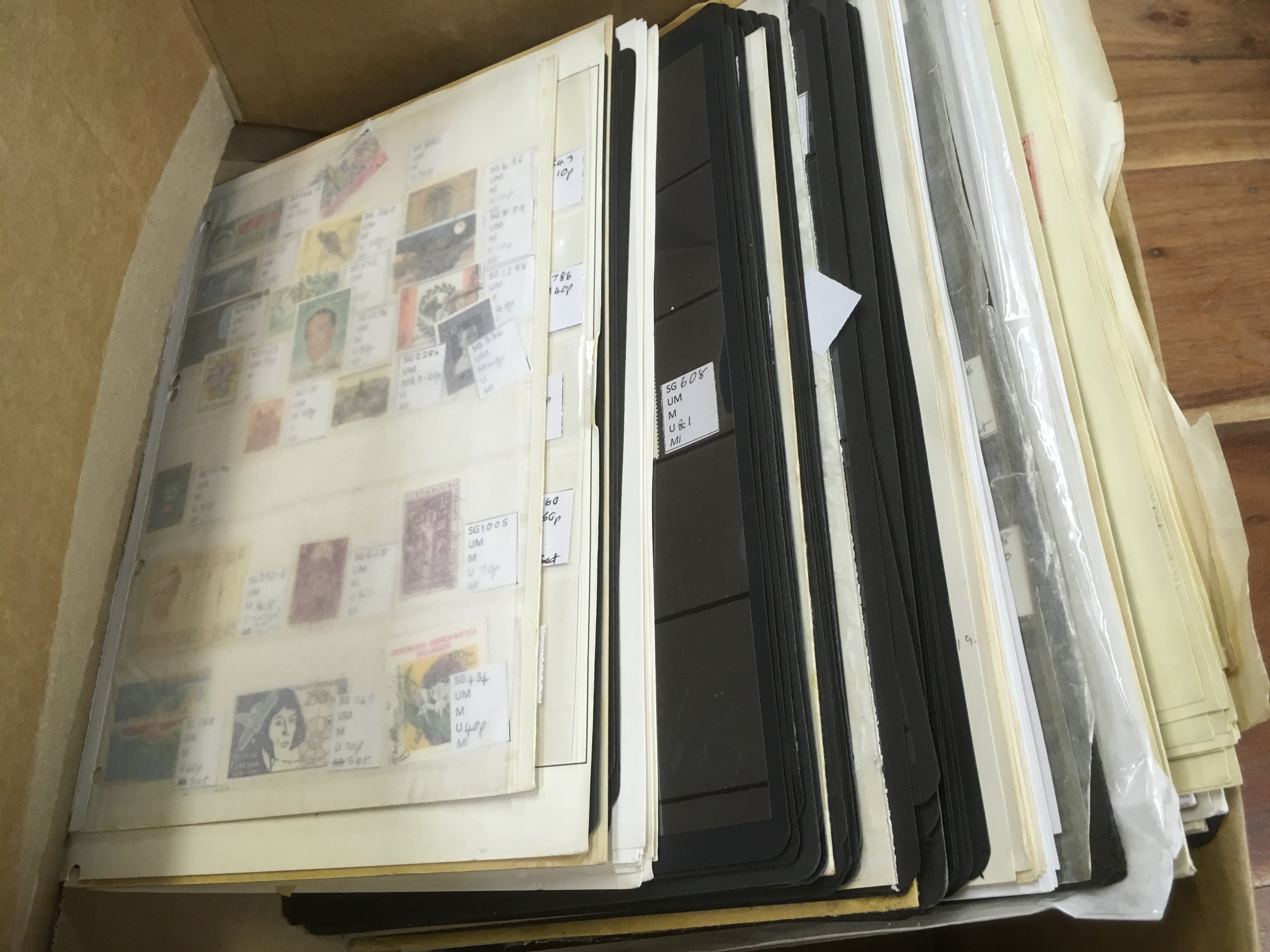 BOX OF FOREIGN STAMPS ON LEAVES AND STOCKCARDS, JAPAN, SWITZERLAND, MOZAMBIQUE, PORTUGAL,