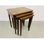 A NEST OF THREE REPRODUCTION MAHOGANY GRADUATED OCCASIONAL TABLES.
