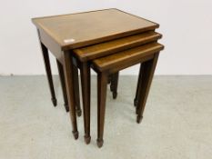 A NEST OF THREE REPRODUCTION MAHOGANY GRADUATED OCCASIONAL TABLES.