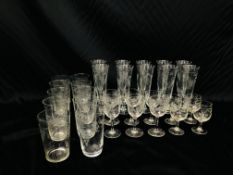 A GROUP OF DRINKING GLASSES INCLUDING TEN FLUTES ENGRAVED WITH EARS OF BARLEY