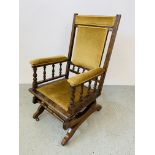 A VICTORIAN GREEN UPHOLSTERED AMERICAN ROCKING CHAIR.