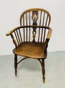 AN ANTIQUE ELM WOOD SEATED STICK BACK ELBOW CHAIR.