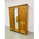 A GOOD QUALITY MODERN HONEY PINE TRIPLE WARDROBE WITH CENTRAL MIRRORED DRAWER MANUFACTURED BY