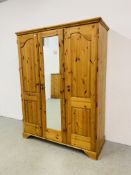 A GOOD QUALITY MODERN HONEY PINE TRIPLE WARDROBE WITH CENTRAL MIRRORED DRAWER MANUFACTURED BY