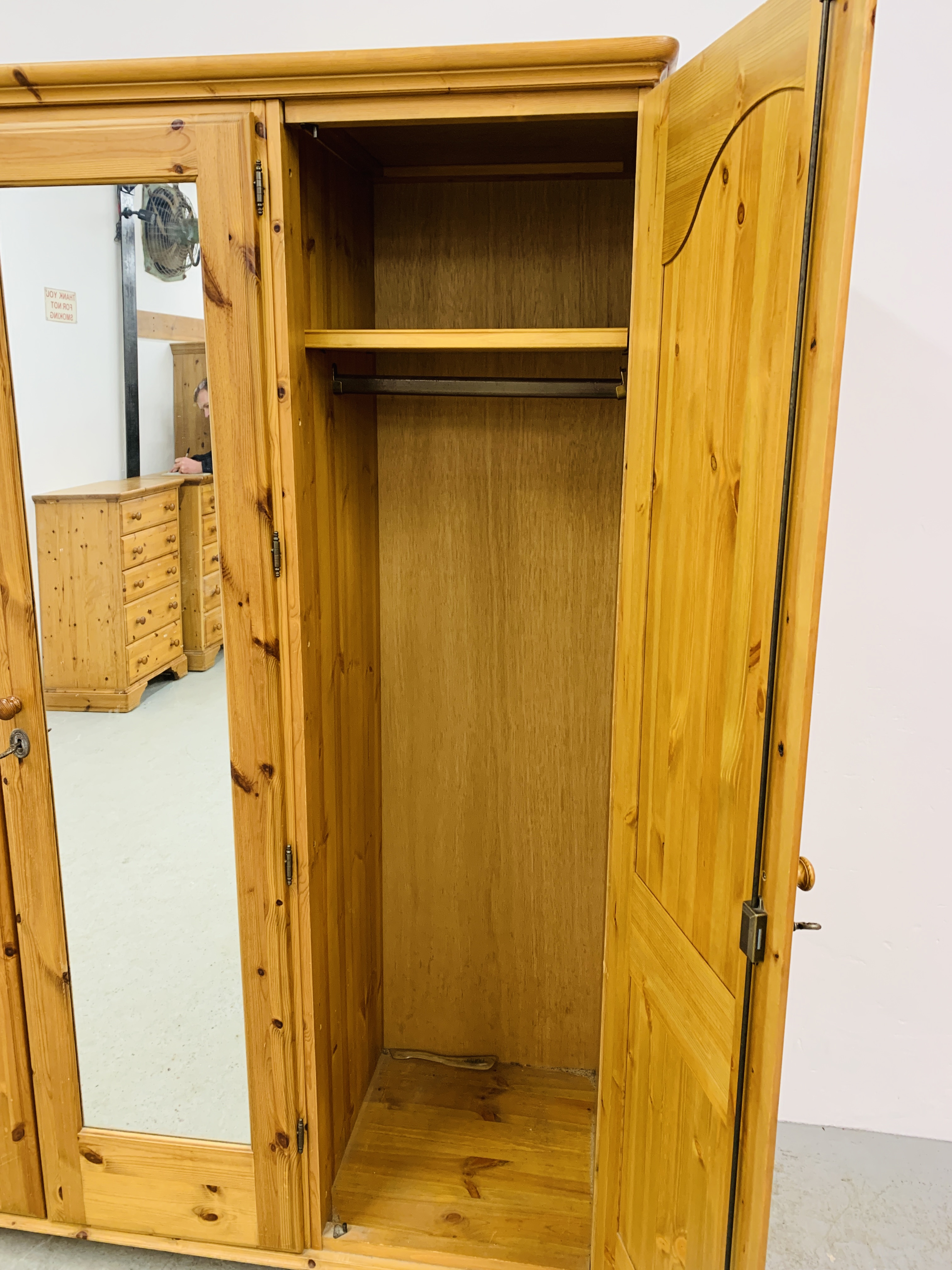 A GOOD QUALITY MODERN HONEY PINE TRIPLE WARDROBE WITH CENTRAL MIRRORED DRAWER MANUFACTURED BY - Image 11 of 12