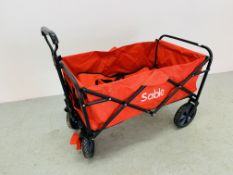 A FOLDING SABLE RED CANVAS TROLLEY