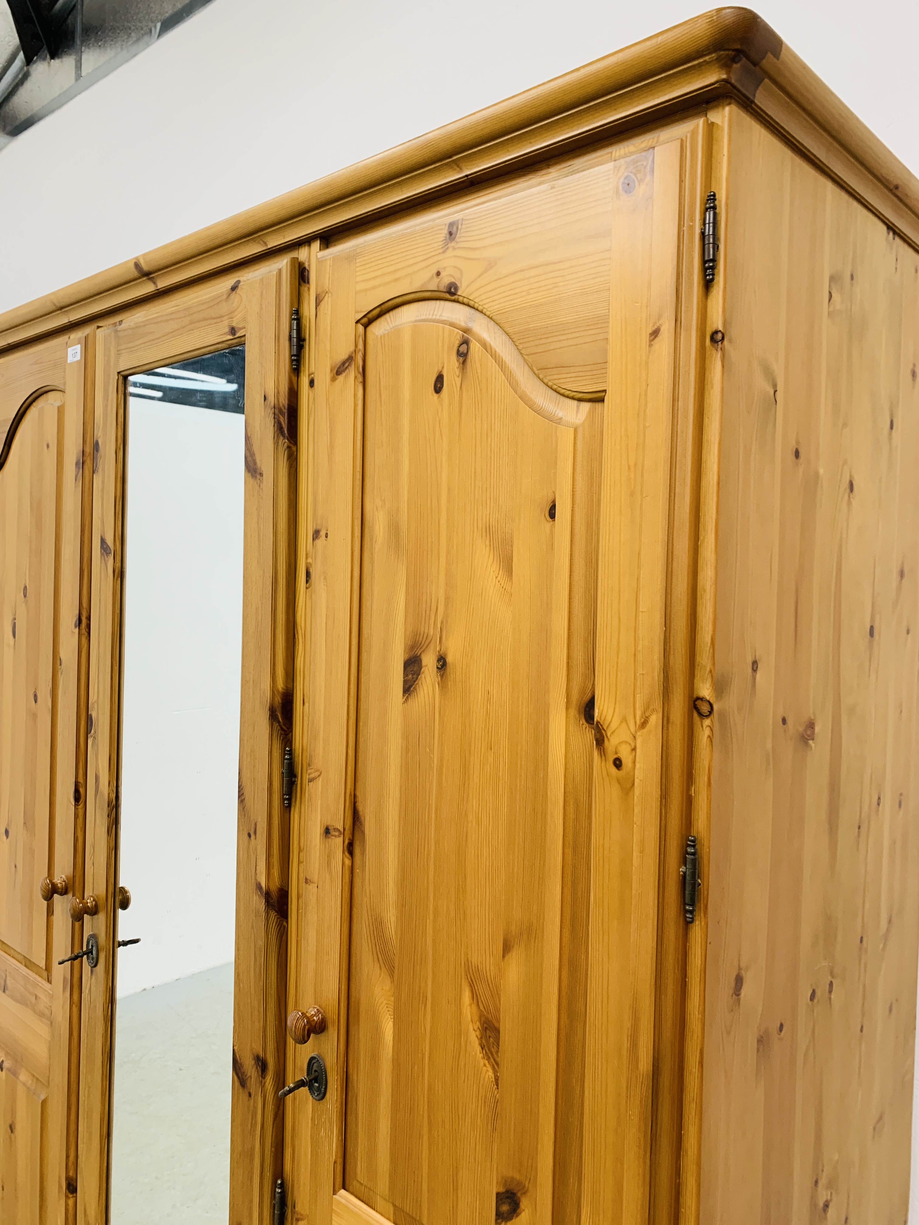 A GOOD QUALITY MODERN HONEY PINE TRIPLE WARDROBE WITH CENTRAL MIRRORED DRAWER MANUFACTURED BY - Image 4 of 12