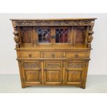 A REPRODUCTION OAK COURT CUPBOARD WITH LINEN FOLD DETAIL AND LEADED GLASS DOORS WIDTH 137CM.