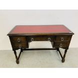 A MAHOGANY FIVE DRAWER KNEEHOLE DESK WITH RED FAUX LEATHER INSERT.