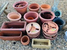 A QUANTITY OF TERRACOTTA LOOK GARDEN PLANTERS AND STANDS.