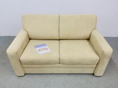 A JOHN LEWIS CREAM SUEDE TWO SEATER SOFA BED.