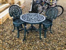 A GREEN PLASTIC CIRCULAR GARDEN TABLE COMPLETE WITH 2 GREEN PLASTIC GARDEN CHAIRS IN SCROLLED