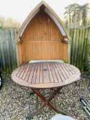 A TWO SEAT GARDEN LOVE ARBOUR AND FOLDING HARDWOOD GARDEN TABLE