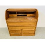 A TEAK FINISH MID CENTURY CYLINDER TOP BUREAU DESK WITH SLIDING WRITING SURFACE