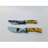 A PAIR OF DECORATIVE STAINLESS KNIVES ONE DEPICTING AN EAGLE THE OTHER WOLVES (BUYER MUST BE 18YRS.