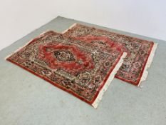 A PAIR OF EASTERN DESIGN CARPETS ON RED BACKGROUND 185CM X 115CM.