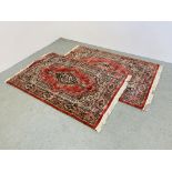 A PAIR OF EASTERN DESIGN CARPETS ON RED BACKGROUND 185CM X 115CM.