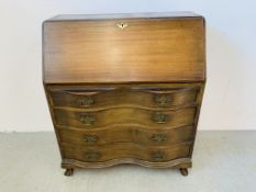 AN OAK 4 DRAWER SERPENTINE BUREAU WITH FOLDING FRONT AND FITTED INTERIOR