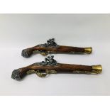 A PAIR OF REPLICA FLINT LOCK PISTOLS WITH BRASS FINISH.