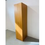 A BEECHWOOD FINISH FULL HEIGHT SHELVED STORAGE CUPBOARD WITH CANTILEVER DOOR WIDTH 50CM.