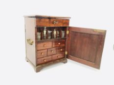 A VINTAGE MAHOGANY APOTHECARY CABINET WITH SLIDES AND VARIOUS BOTTLES ETC W 28CM, D 24CM, H 38CM.