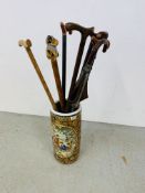 A REPRODUCTION ORIENTAL CERAMIC STICK STAND ALONG WITH 8 VARIOUS WALKING STICKS