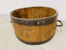 AN ANTIQUE OAK METAL BOUND MEASURING BUSHEL STAMPED ER 146 DIAMETER 49CM, HEIGHT 25CM.