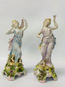A PAIR OF C19TH GERMAN HARD PASTE FIGURES OF DANCING MAIDENS STANDING ON FLORAL ENCRUSTED BASES