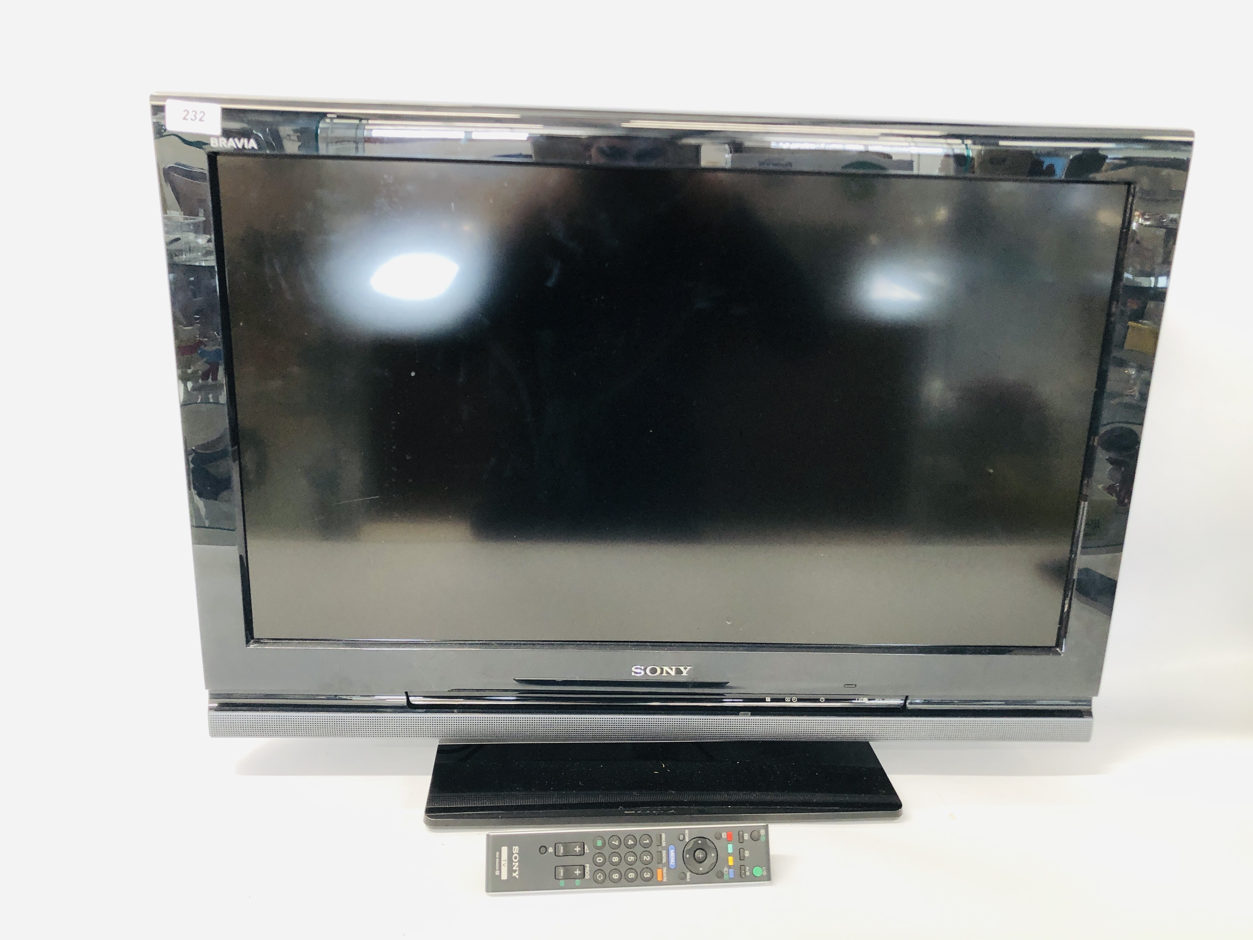 A SONY 32 INCH FLAT SCREEN TV COMPLETE WITH REMOTE - SOLD AS SEEN.