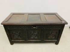 AN ANTIQUE OAK COFFER WITH HAND CARVED PANELS AND RAIL WIDTH 125CM. DEPTH 59CM. HEIGHT 66CM.