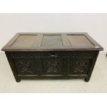 AN ANTIQUE OAK COFFER WITH HAND CARVED PANELS AND RAIL WIDTH 125CM. DEPTH 59CM. HEIGHT 66CM.