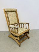 AN EDWARDIAN ROCKING ARM CHAIR WITH UPHOLSTERED SEAT AND BACK.