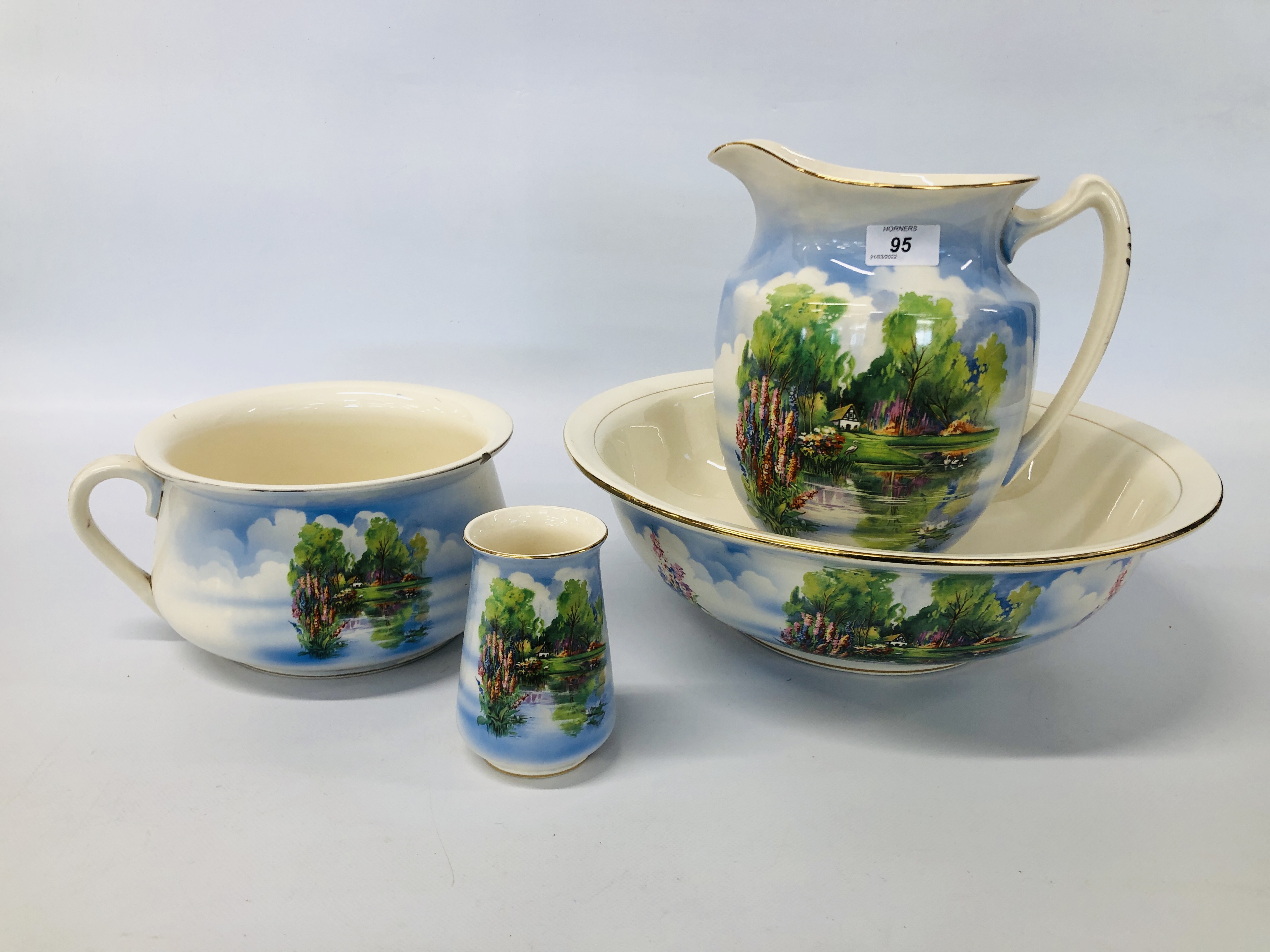 A VINTAGE FALCON WARE DECORATED WASH JUG AND BOWL SET ALONG WITH MATCHING VASE AND CHAMBER POT.