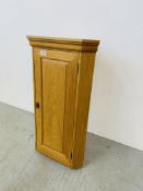 A SOLID LIGHT OAK HANGING CORNER CUPBOARD WITH SHELVED INTERIOR HEIGHT 84CM.