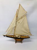 A MODEL POND YACHT ON STAND