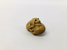 A NETSUKE BEARING INITIALS