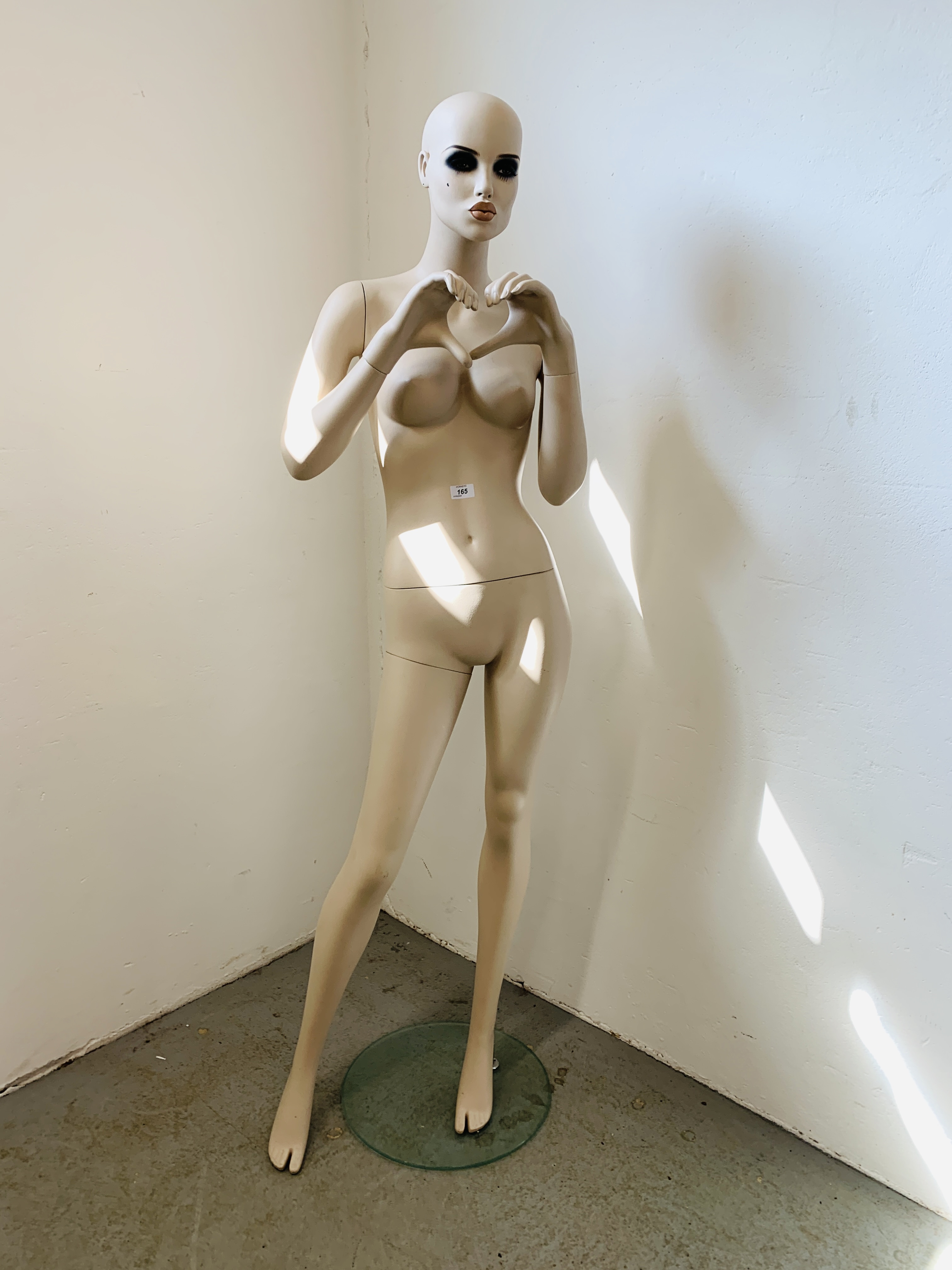 A FEMALE SHOP MANNEQUIN.