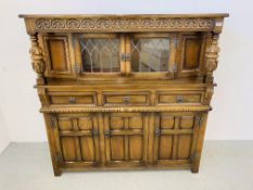 A REPRODUCTION OAK FINISH COURT CUPBOARD WITH LEADED GLASS DOORS W 138CM, D 45CM, H 137CM.