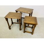 A GRADUATED NEST OF THREE OAK OCCASIONAL TABLES.