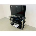 A PANASONIC VIERA 32 INCH TELEVISION WITH REMOTE ON GLASS THREE TIER STAND + HUMAX HD RECORDER WITH