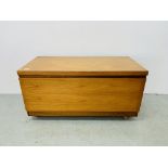 A MID CENTURY TEAK LOW LEVEL CABINET WITH FALLING FRONT WIDTH 102CM. DEPTH 49CM. HEIGHT 52CM.