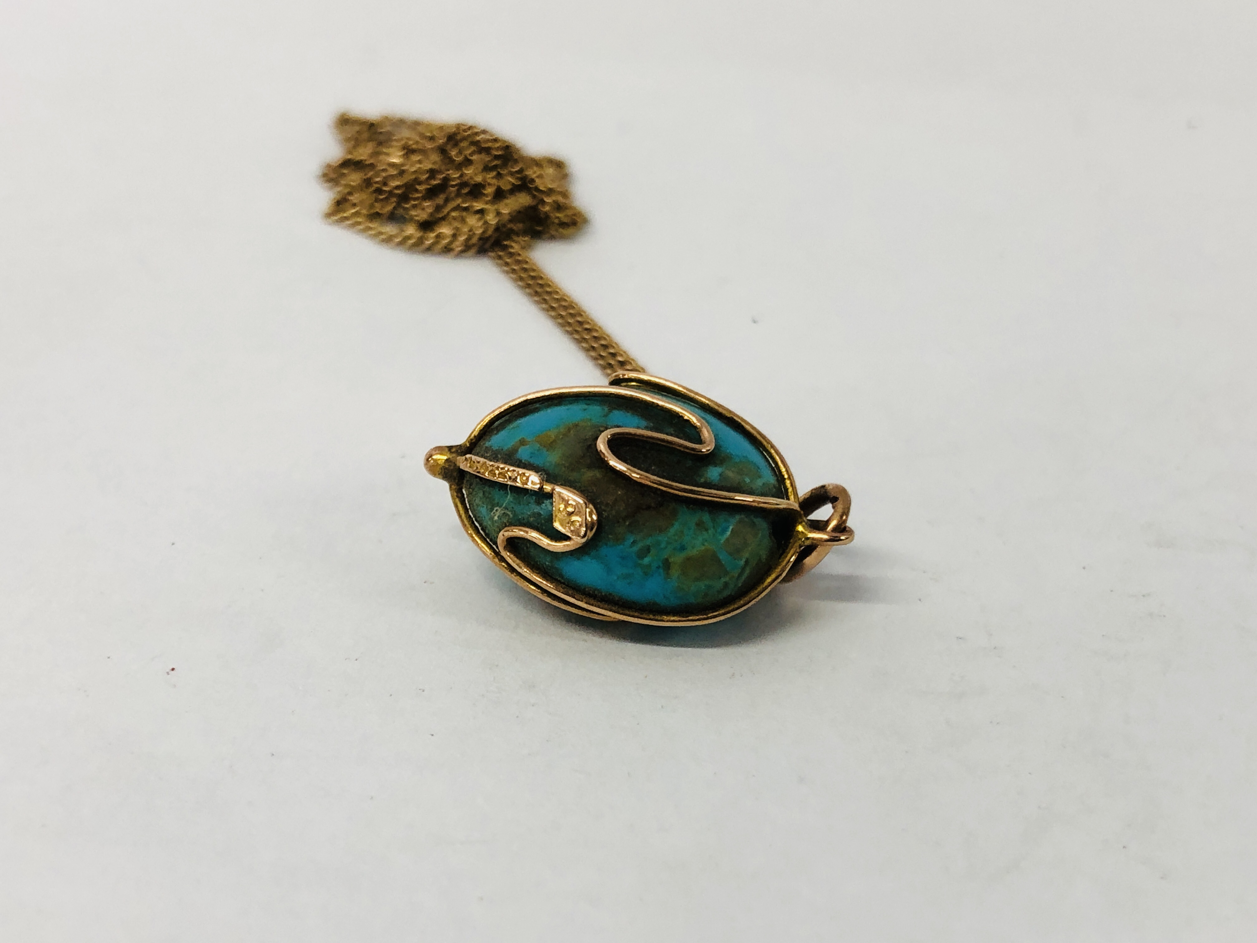 A 9CT GOLD CHAIN SUPPORTING AN OVAL BLUE HARD STONE PENDANT. - Image 3 of 7