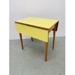 A YELLOW 1950'S FORMICA TOPPED DROP FLAP KITCHEN TABLE