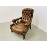 AN ANTIQUE MAHOGANY AND BROWN LEATHER BUTTON BACK ARM CHAIR WITH CARVED DETAIL