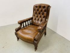 AN ANTIQUE MAHOGANY AND BROWN LEATHER BUTTON BACK ARM CHAIR WITH CARVED DETAIL