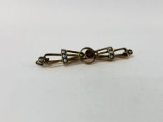 VINTAGE YELLOW METAL BROOCH SET WITH CENTRAL GARNET AND SEED PEARLS.
