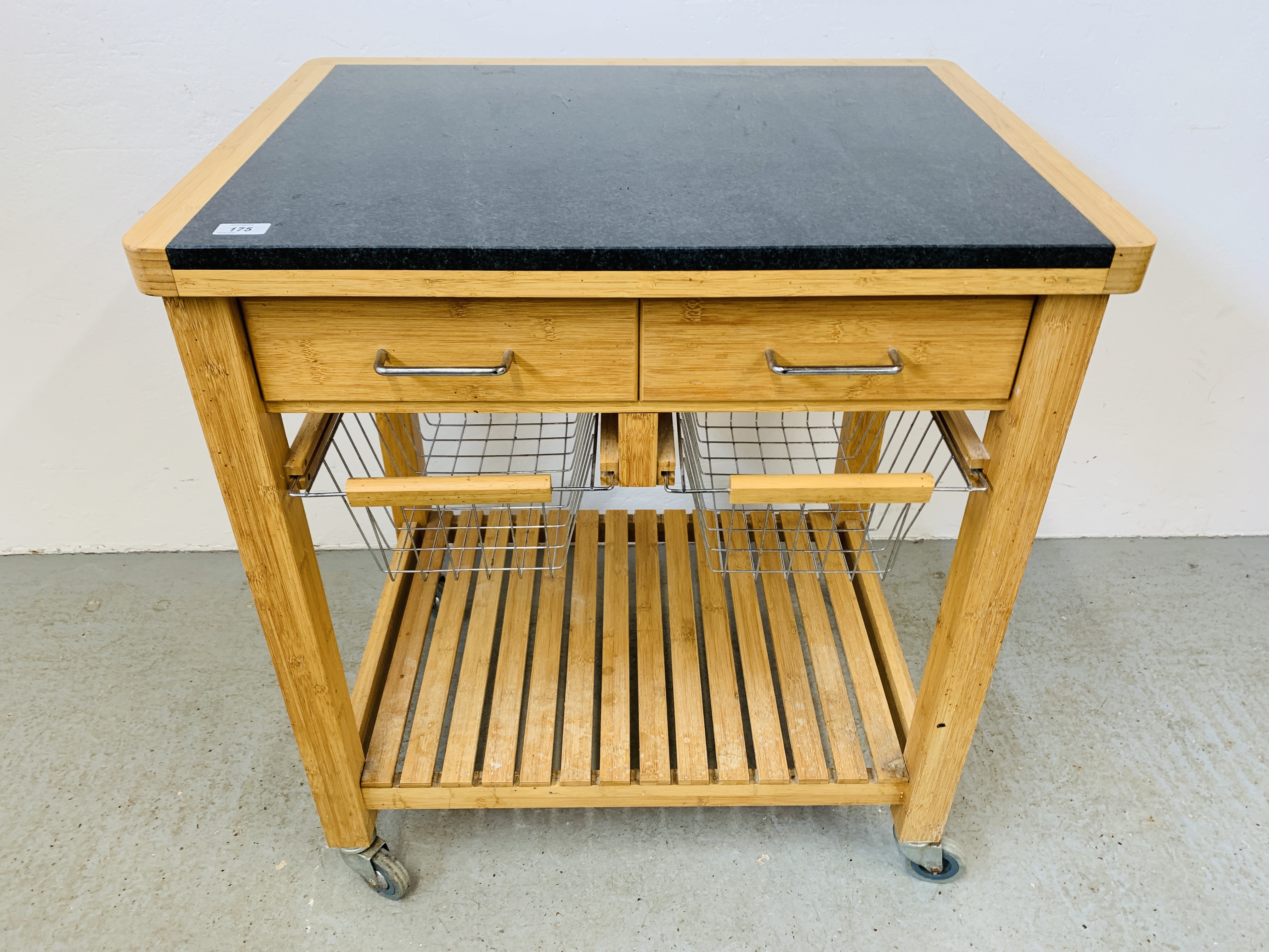 A TWO DRAWER KITCHEN WORKSTATION WITH SOLID GRANITE PREPARATION TOP, WHEELED.