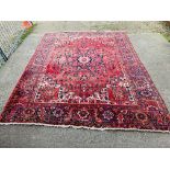 A GOOD QUALITY RED PATTERNED EASTERN CARPET 3.75M X 2.9M.