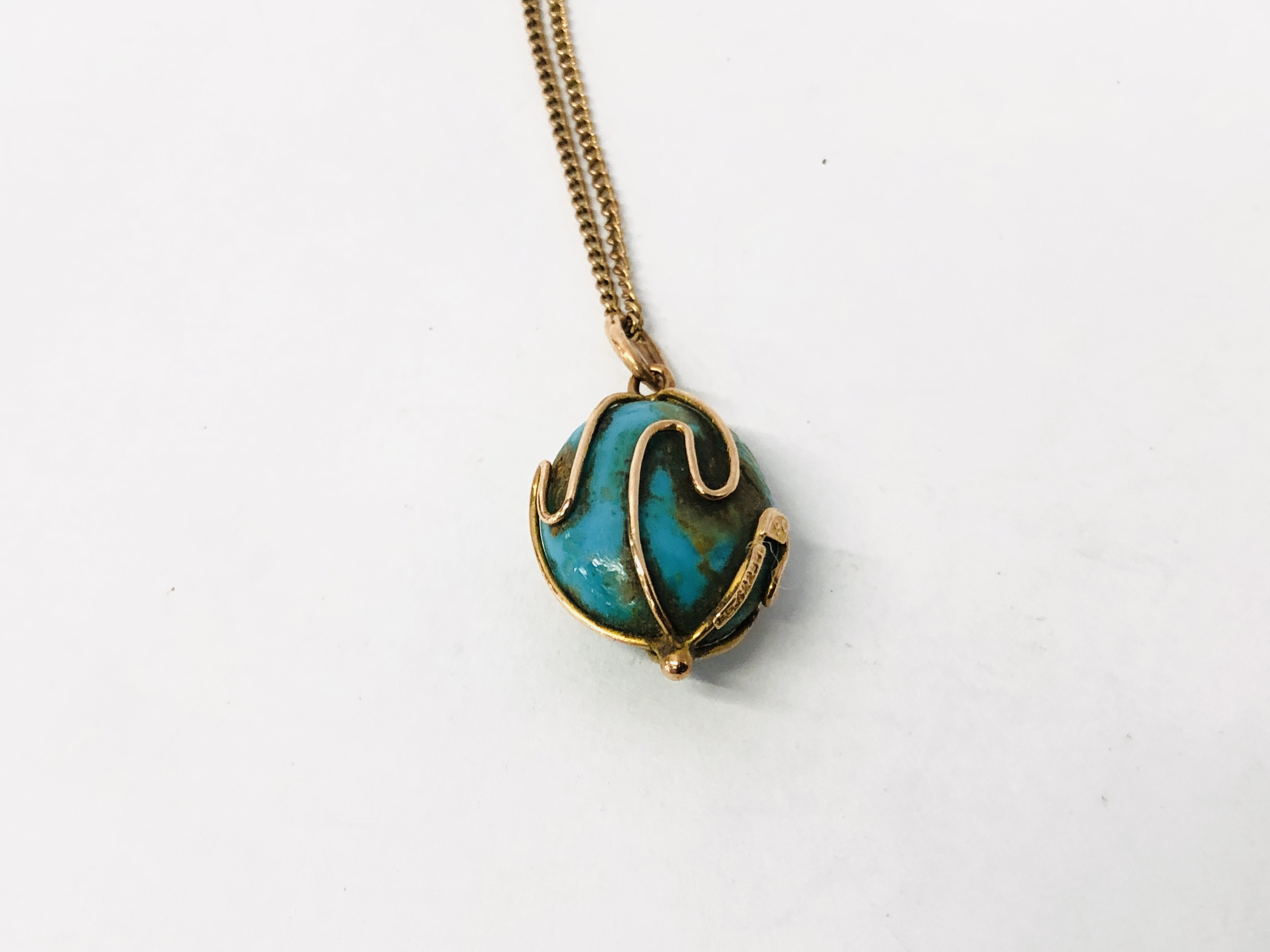 A 9CT GOLD CHAIN SUPPORTING AN OVAL BLUE HARD STONE PENDANT. - Image 2 of 7